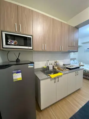 a kitchen with a refrigerator and a microwave at Prestige Suite at Tulip Gardens Southwoods in Jalang
