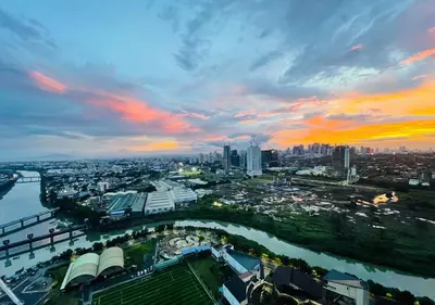 an aerial view of a city at sunset at 2-Bedroom Condo with Swimming Pool in Manila