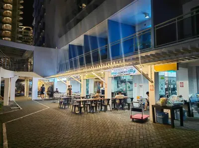 a restaurant with tables and chairs in a building at 1BR Condotel at Azure Urban Resort Near Airport #AZ06 in Manila