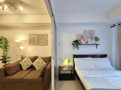 a living room with a couch and a bed at 1BR Condotel at Azure Urban Resort Near Airport #AZ06 in Manila