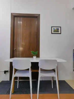 a table with two white chairs and a plant on it at 1BR Condotel Ridgewood Towers Taguig City #RW15 in Manila