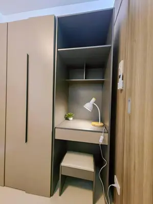 a room with a closet with a desk and a lamp at 1BR Condotel with Balcony at FAME Residences #FM36 in Manila