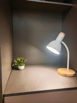 a table with a lamp and a potted plant at 1BR Condotel with Balcony at FAME Residences #FM36 in Manila