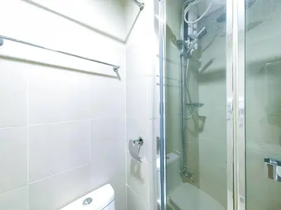 a bathroom with a shower with a glass door at 1BR Condotel with Balcony at FAME Residences #FM36 in Manila