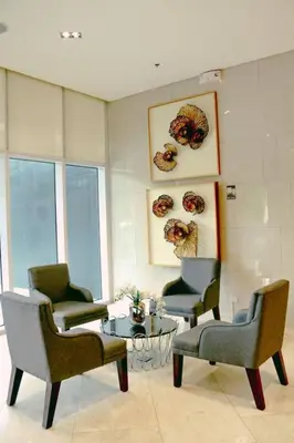 a waiting room with chairs and a coffee table at Hotel style Unit 2924 Fame in Manila