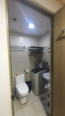 a small bathroom with a toilet and a sink at Jinh's place to STAYCATION in Manila