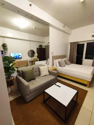 a living room with a couch and a bed at Jinh's place to STAYCATION in Manila