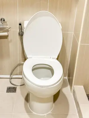 a bathroom with a white toilet in a stall at 823 Air Condo Shell Staycation Mall of Asia Walkable in Manila