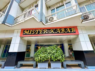 a building with two benches in front of a store at 823 Air Condo Shell Staycation Mall of Asia Walkable in Manila