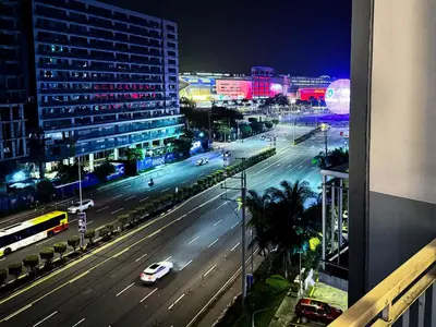 a city street at night with cars on the road at 823 Air Condo Shell Staycation Mall of Asia Walkable in Manila
