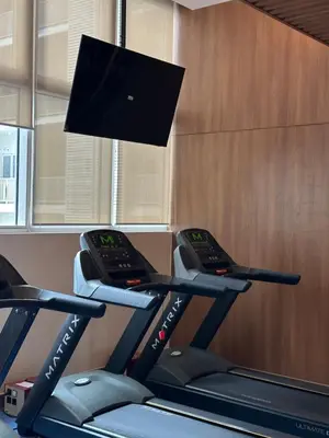 a room with three treadmills on a treadmill at Park Mckinley West 1BR in Manila