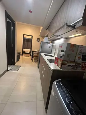a kitchen with a stove and a counter top at Park McKinley West unit 9Y Tower B in Manila