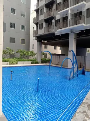an empty swimming pool in front of a building at The Manor at S Residences in Manila
