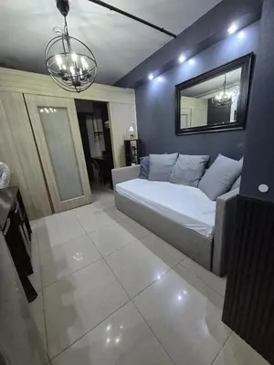 a bedroom with a bed and a mirror on the wall at Industrial Design Bachelor's Pad with Pool View in Shore Residences in Manila