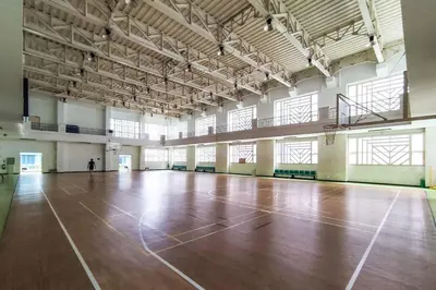 an empty gym with a wooden floor and windows at Japanese Stylish Condo in Makati in Manila