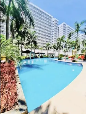 a large swimming pool in front of a large building at Near MOA Manila Bay Airport via NAIAX Balcony-Pool View WiFi SHELL Residences in Manila