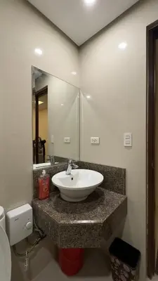 a bathroom with a sink and a mirror at New Cozy Condo in Eastwood in Manila