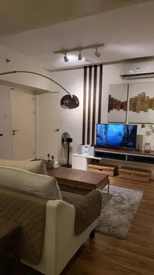 a living room with a couch and a tv at 3BR Elegant & Central Loc- Netflix, WiFi, MiniBar! in Manila