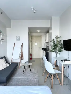 a living room with a couch and a table at Vibrant Makati Studio in Manila