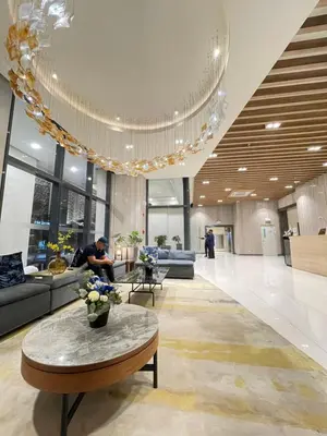 a lobby with couches and a table in a building at Cozy place across Mitsukoshi Mall in Manila
