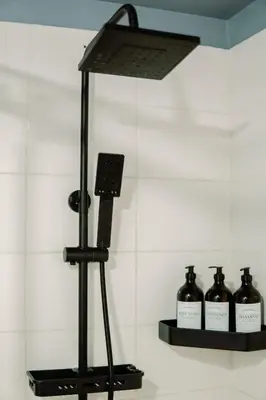 a camera on a tripod next to bottles of wine at Cozy and Spacious Studio at SOMA BGC Near SM Aura and Bonifacio High Street in Manila