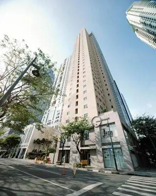 a tall white building with a clock in front of it at Cozy and Spacious Studio at SOMA BGC Near SM Aura and Bonifacio High Street in Manila