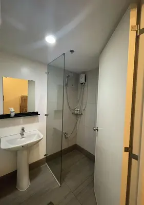 a bathroom with a shower and a sink at The Cozy Corner in Manila