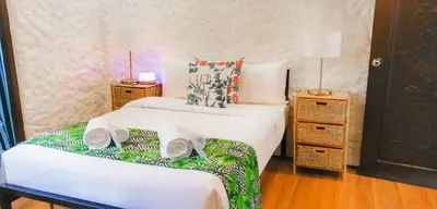 a bedroom with two beds and two night stands at Kasa Silang by Araw Residences in Cavite