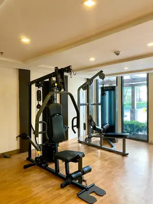 a gym with two tread machines in a room at Cluster 2, 81 Newport Blvd Near NAIA T3 in Manila