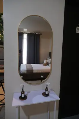a mirror over a white vanity with a bed in a room at Cluster 2, 81 Newport Blvd Near NAIA T3 in Manila
