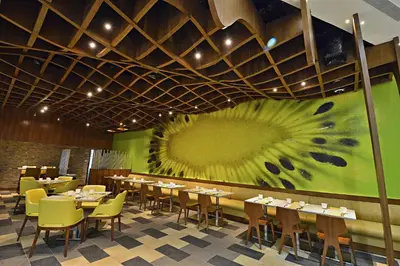 a dining room with tables and chairs and a large painting at City of Dreams - Nobu Hotel Manila in Manila