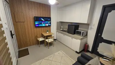 a small kitchen with a table and a microwave at Flat 35, Unit D in Manila