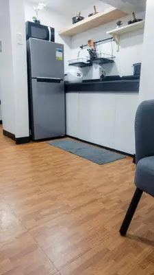 a kitchen with a refrigerator and a counter top at Modern Condo for 6, with Kitchen, Wi-Fi & Netflix, Near MRT Boni in Manila