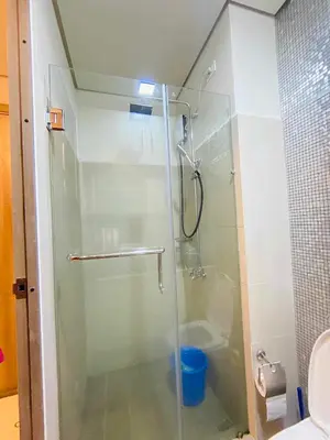 a glass shower in a bathroom with a toilet at Coast Stay by J 41st floor Penthouse in Manila