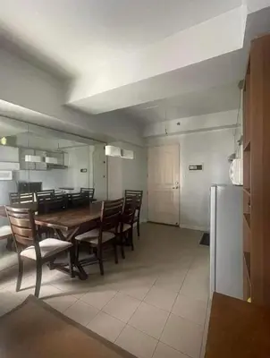 a kitchen and dining room with a table and chairs at Avida San lorenzo Tower 1 in Manila