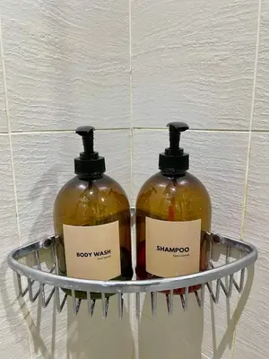 two bottles of soap on a shelf in a bathroom at 1 Bedroom Azure Staycation Near NAIA in Manila