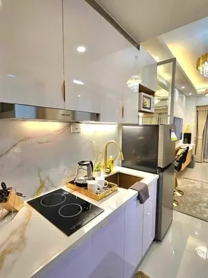 a kitchen with a sink and a stove top oven at Skyport Luxe in Manila
