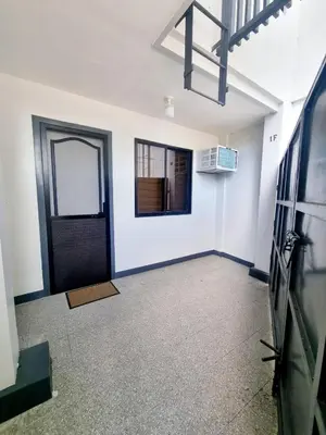 an empty room with a door and a window at Flat 35, Unit 1F in Manila