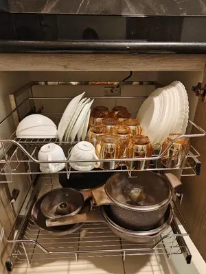 a drawer of an oven with food and dishes at City Serenity Escape in Manila