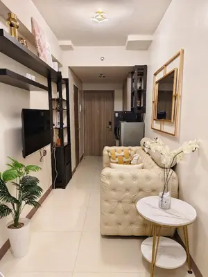 a living room with a couch and a table at City Serenity Escape in Manila