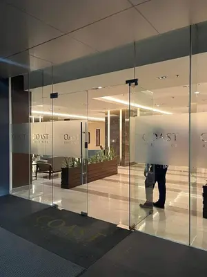 a person standing behind a glass wall in a building at City Serenity Escape in Manila