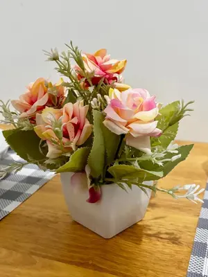 a bouquet of flowers in a vase on a table at Ikigai Delta Makati Condo Luxury Sunset View in Manila
