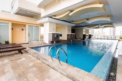 a large swimming pool in a hotel room at Explore Manila Trendy 1BR unit in Birch Tower in Manila