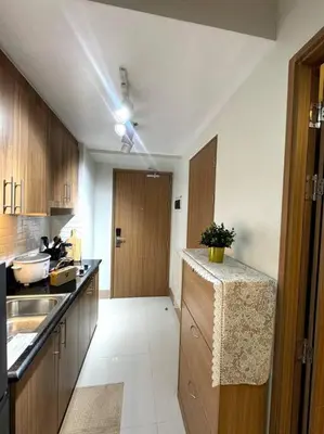 a kitchen with a sink and a counter top at Shore 3 katkat staycation in Manila