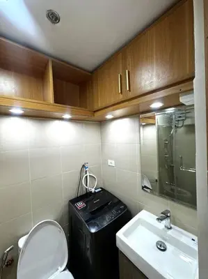 a small bathroom with a toilet and a sink at Shore 3 katkat staycation in Manila