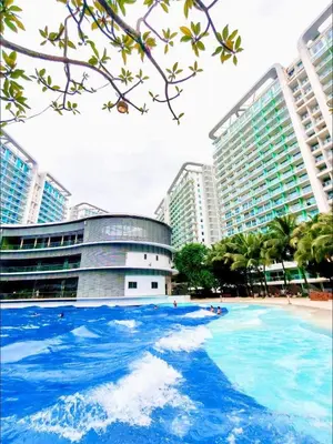 a large pool of blue water in front of buildings at Azure Resort Paranaque deluxe room unit 1601 st tropez tower in Manila