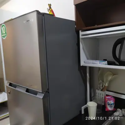a refrigerator with its door open in a kitchen at Staycation by Estelle in Manila