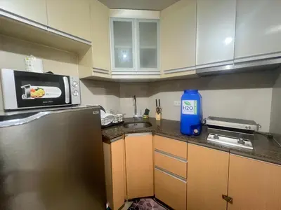 a small kitchen with a sink and a microwave at One palm tree villas &Two palm tree villas in Manila