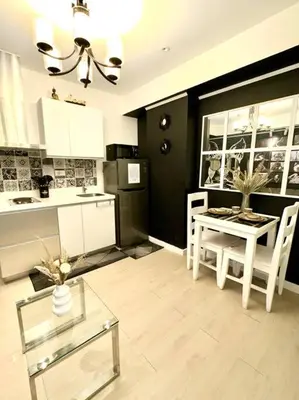 a kitchen with a table and a dining room at Azure 1BR with Projector in Manila