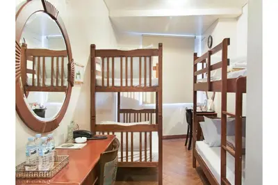 a room with two bunk beds and a mirror at Townhouse OAK Metro Manila Near Osmena Highway PNR Pasay formerly Avitel Hotel in Manila